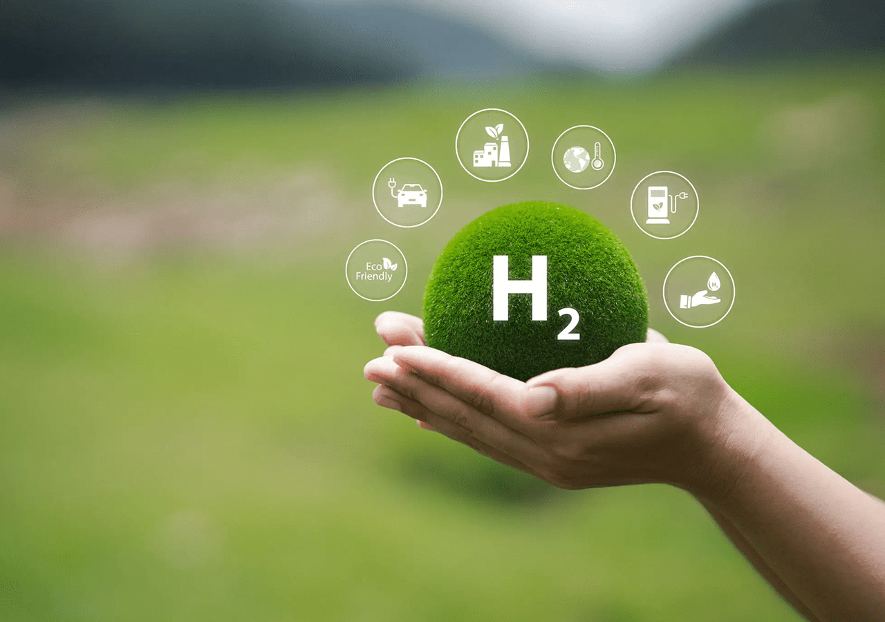 Hand holding a green sphere with hydrogen energy icons and H2 symbol.